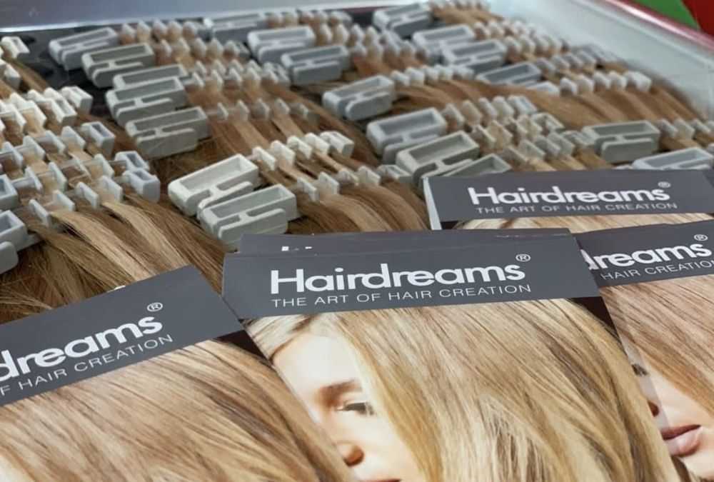 Hair extensions displayed with Hairdreams packaging cards.